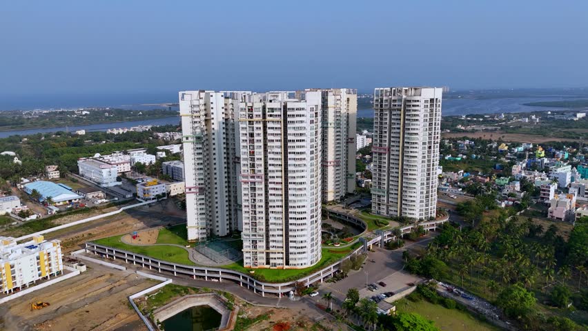 Aerial video of 4 highrise residential apartment towers loacted in India with backwaters