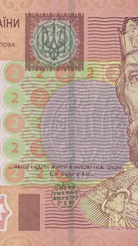 Vertical video showcasing intricate security patterns and Yaroslav the Wise's historic quote on left side of authentic Ukrainian two hryvnia banknote with smooth zoom-in effect