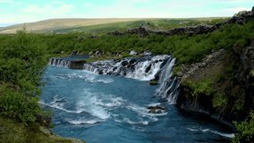 Witness the breathtaking flow of Barnafoss and Hraunfossar, cascading gracefully over lava formations in Iceland. This natural wonder showcases vibrant colors and stunning landscape views. - Powered by Shutterstock - Get 15% off with code: PIKWIZARD15