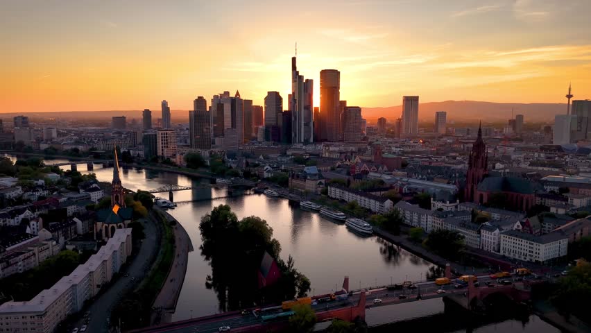 Aerial summer sunset view of the skyline of Frankfurt am Main, Germany, wit the sun setting behind the office skyscrapers