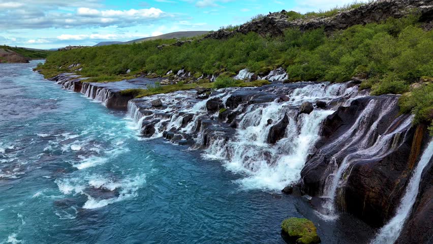 Experience the mesmerizing flow of Barnafoss and Hraunfossar waterfalls cascading into the crystal-clear waters below. Nestled in Icelands stunning landscape, these natural wonders inspire awe.