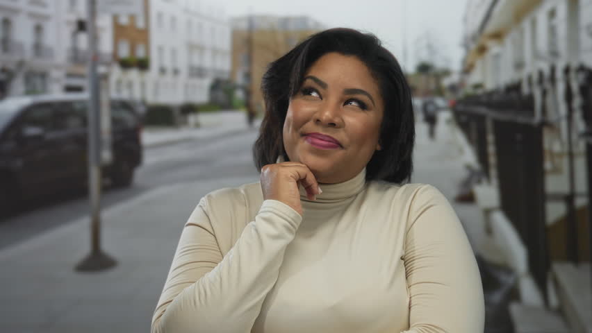 Woman smiling in an urban outdoor setting with a background of city street and cars, showcasing a confident plus-size hispanic appearance.