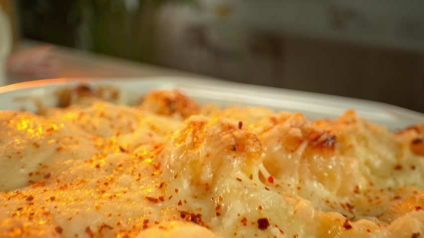 4K slow motion video of a gooey cheese pull from hot mac and cheese. Ideal for comfort food visuals, cooking content, and recipe-based marketing.