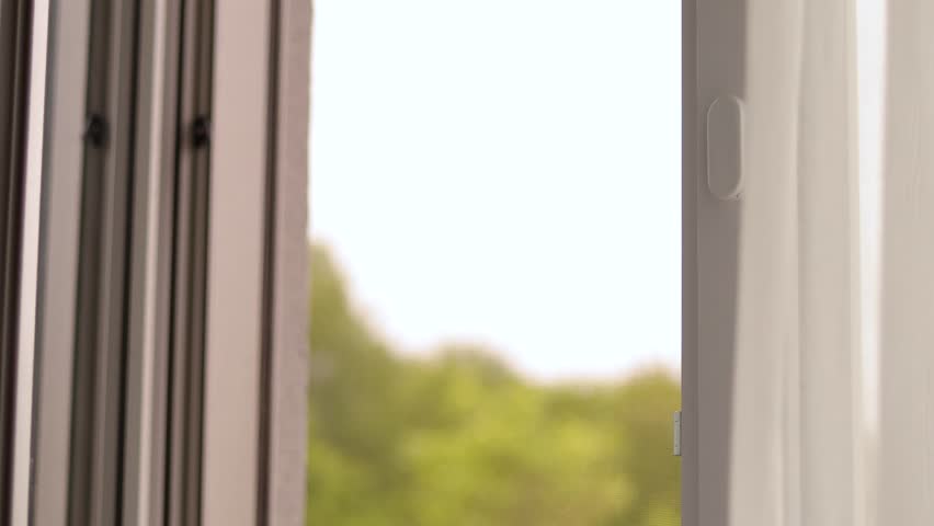 Close window to enjoy tranquility on a calm day. Sunlight filters into the cozy living space, creating a serene and inviting environment just before dusk