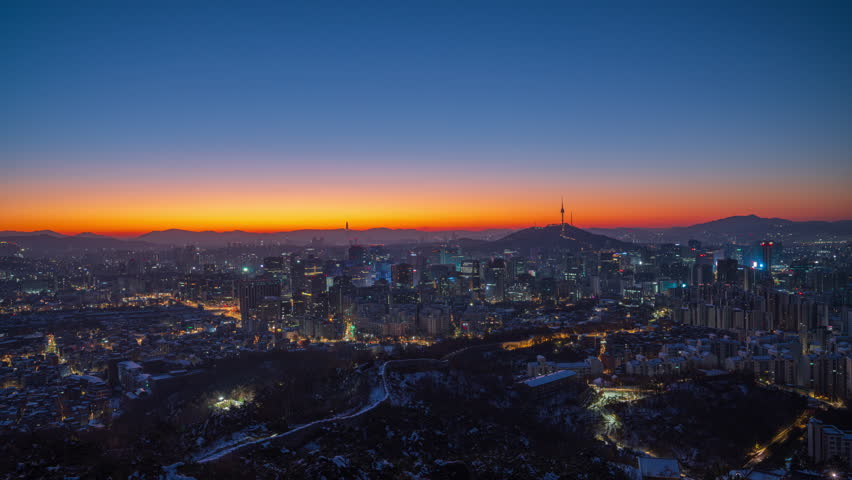 Seoul City. Morning view of Seoul with Namsan Tower and snow covered with the first sunlight of the day. Inwangsan Mountain Viewpoint in Seoul, South Korea.Time Lapse Video.