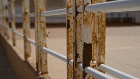 Rusty metal fence outdoors on a sunny day, displaying weathered texture and decay in a bright urban setting. - Powered by Shutterstock - Get 15% off with code: PIKWIZARD15