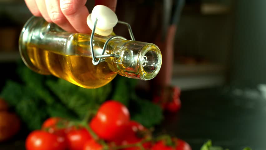 4K slow motion video of olive oil falling onto a raw salmon fillet. A close-up food prep scene ideal for cooking content, recipe visuals, or healthy eating themes.
