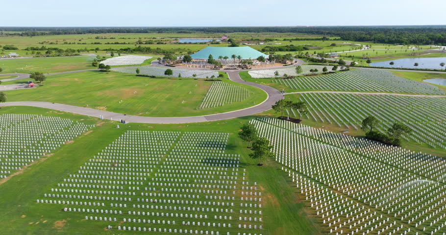Army veteran cemetery with white headstones. Tombs of retired military soldiers. Memorial Day concept.