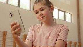 Caucasian teenager girl child using mobile phone upset student schoolgirl pupil lost error internet dissatisfied connection smartphone failure app school bad problem gym addiction sport online sad kid - Powered by Shutterstock - Get 15% off with code: PIKWIZARD15