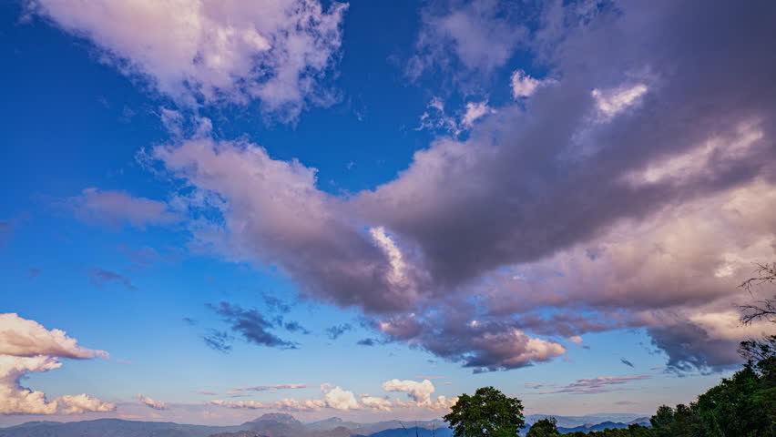 time lapse the white clouds weaving in and out of each other in blue sky,
each moment creating a new pattern and a new beauty.
cloudscape traveling over a wide space of nature clear sky.