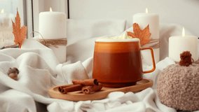 Adding whipped cream Pumpkin spiced latte morning warming coffee. Fall Drinks for Halloween Thanksgiving Holiday beverage Autumn spicy cinnamon flavor seasonal hot drinking in cozy orange cup - Powered by Shutterstock - Get 15% off with code: PIKWIZARD15