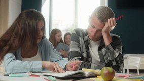 High school students pupils Caucasian girl guy classmates schoolgirl help schoolboy in library class studying learning together teach university education book couple teens woman man learn exam study - Powered by Shutterstock - Get 15% off with code: PIKWIZARD15