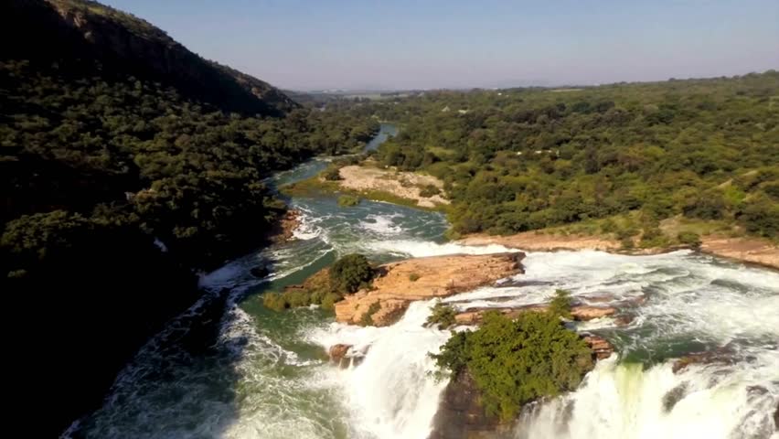 Aerial View of Cascading Waterfall in Lush Green Landscape