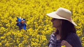 pinwheel, woman side profile in yellow flower field, playful nature vibe - Powered by Shutterstock - Get 15% off with code: PIKWIZARD15