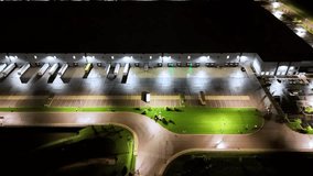 Drone glides above an industrial warehouse complex at night, capturing glowing lights, shadows, and symmetrical structures. A calm yet powerful image of nighttime logistics infrastructure in operation - Powered by Shutterstock - Get 15% off with code: PIKWIZARD15