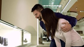 Couple admires sparkling jewelry in a chic boutique display - Powered by Shutterstock - Get 15% off with code: PIKWIZARD15