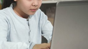 Focused little girl deeply engaged with her laptop - Powered by Shutterstock - Get 15% off with code: PIKWIZARD15