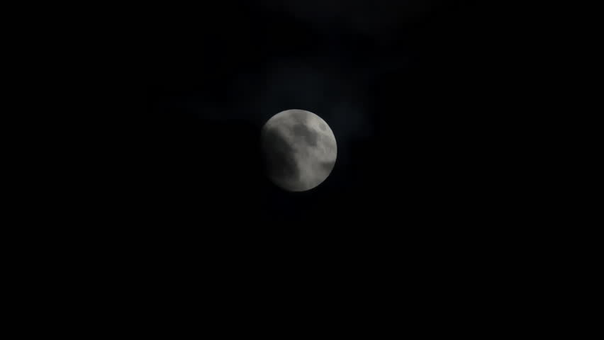 View at full moon at cloudy night dark sky. Scary atmosphere. Close up shot