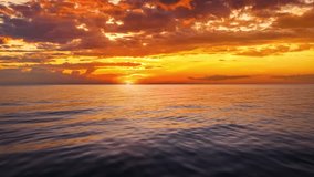Aerial flight or captains boat POV over the calm ocean into the golden summer sunset with orange and red clouds - Powered by Shutterstock - Get 15% off with code: PIKWIZARD15