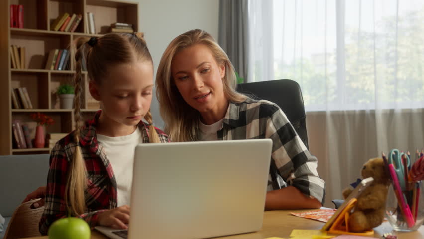 Caring Caucasian family learning together e-learning laptop at home female woman help mother mom parent teaching how to use computer cyberspace little kid child girl daughter schoolgirl pupil speaking - Powered by Shutterstock - Get 15% off with code: PIKWIZARD15
