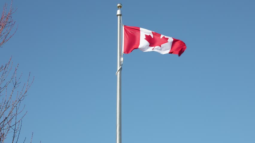 Canadian flag along blue sky