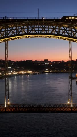 Sunset Luis I Bridge At Porto In Porto District Portugal. Sunset City Scene. Illuminated Bridge Landscape. Luis I Bridge At Porto District Portugal. Beautiful Dusk Skyline.