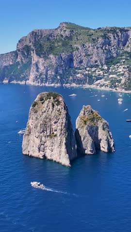 Faraglioni Island At Capri In Naples Italy. Beach Landscape. Giant Cliffs Scene. Faraglioni Island At Capri In Naples Italy. Gulf Of Naples Skyline. Mediterranean Sea Coast. Scenic Capri Island.