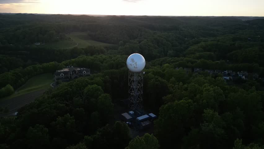 Aerial circling weather radar tower in Charleston West Virginia mountains