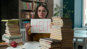 Sad worried tired exhausted girl Caucasian woman high school student teacher helpless stressful books studying learning college university library problem overwork holding text help education overload - Powered by Shutterstock - Get 15% off with code: PIKWIZARD15