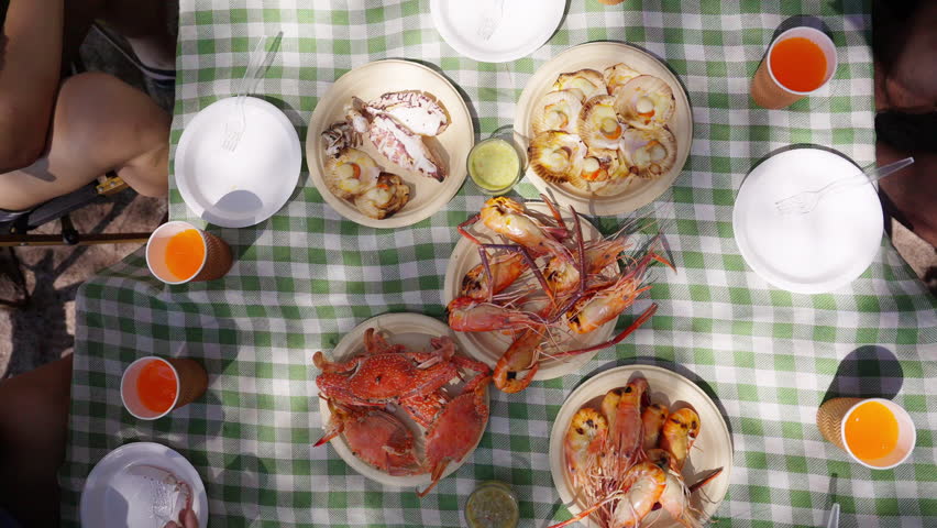 Happy Asian man and woman travel the sea on summer beach holiday vacation. Group of People friends enjoy and fun outdoor lifestyle meeting party eating seafood together on tropical island beach.