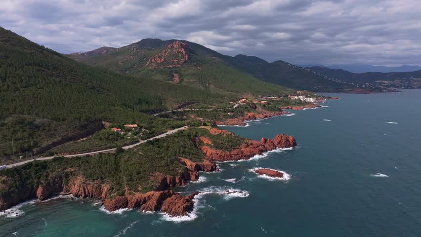 Aerial view of road hugging rocky coastline in Esterel mountains, France