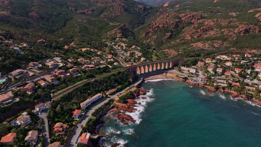 Aerial view of Saint-Raphael village with coastal road and greenery