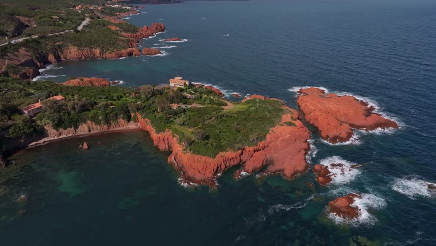 Aerial view of red cliffs and highway by the Mediterranean Sea, France