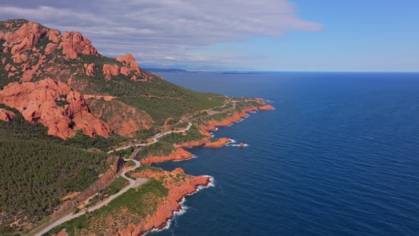 Aerial view of coastal highway winding through Esterel hills, France