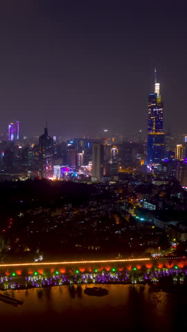 night time illuminated nanjing city wall lakeside downtown district aerial vertical timelapse panorama 4k china