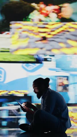 Vertical Video Caught in the toxic cycle of social media, disturbed man shows signs of social anxiety and obsessive behavior driven by excessive information online content, harmful smartphone