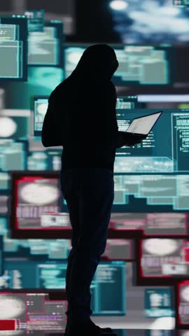 Vertical Video Conceptual representation of cyber crime with male hacker exploiting system vulnerability, using programming technique and surveillance to override digital defenses and leak information