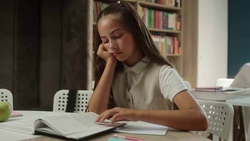 Bored schoolgirl Caucasian girl kid child pupil read book in school library sad tired learner student teenager upset frustrated boring lesson exhausted sleepy reading studying in classroom education - Powered by Shutterstock - Get 15% off with code: PIKWIZARD15