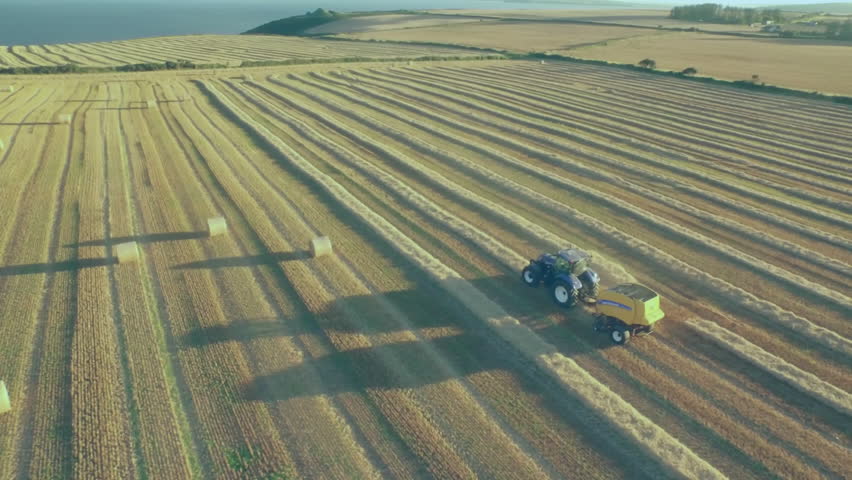 upon baling starting tractor towing baler driving, while icons multiplying then fading showing data. Agriculture, precision farming, data visualization, aerial view, rural landscape, digital overlay, - Powered by Shutterstock - Get 15% off with code: PIKWIZARD15