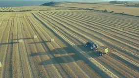 upon baling starting tractor towing baler driving, while icons multiplying then fading showing data. Agriculture, precision farming, data visualization, aerial view, rural landscape, digital overlay, - Powered by Shutterstock - Get 15% off with code: PIKWIZARD15