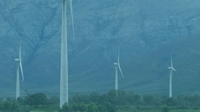 At start code lines appearing over wind turbines, drifting and pulsing visualizing data flow. Renewable, technology, sustainability, digital, data, innovation, environment - Powered by Shutterstock - Get 15% off with code: PIKWIZARD15