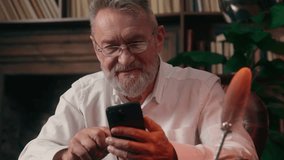 Old Caucasian man using mobile phone smartphone male mature senior gadget businessman smiling digital device business home online internet social media chatting indoor office addict pensioner browsing - Powered by Shutterstock - Get 15% off with code: PIKWIZARD15