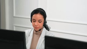 Businesswoman wearing headset working in office to support remote customer or colleague. Call center, telemarketing, customer support agent provide service on telephone video conference call crucial - Powered by Shutterstock - Get 15% off with code: PIKWIZARD15