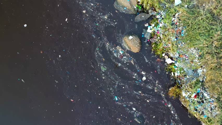 Aerial Top View of Polluted Lake Shore with Plastic Waste and Environmental Damage