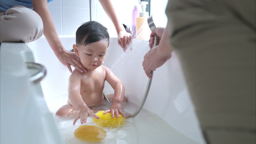 Happy time for bath, Asian kid and parents enjoying bath in the bathroom