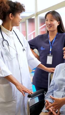 Medical professionals provide care and support to a senior woman in a wheelchair, creating a positive and reassuring environment