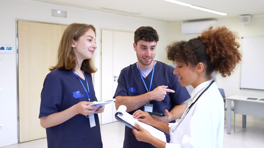 Healthcare professionals, including nurses and a doctor, collaborate, discussing patient charts and treatment plans in a hospital setting - Powered by Shutterstock - Get 15% off with code: PIKWIZARD15