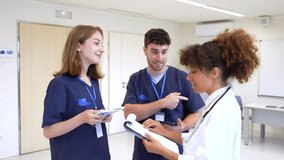 Healthcare professionals, including nurses and a doctor, collaborate, discussing patient charts and treatment plans in a hospital setting - Powered by Shutterstock - Get 15% off with code: PIKWIZARD15