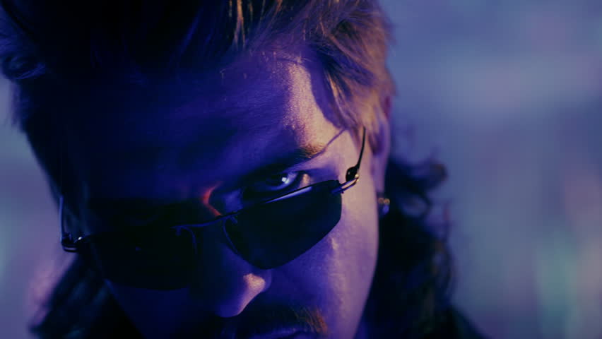 Portrait: Handsome male in retro style, vaporwave actor vintage TV series. Face of a cool man from the 1990 1980 wearing sunglasses, retrowave hair style and mustache. Nostalgia