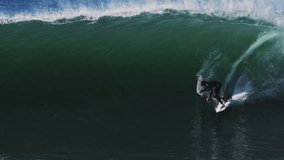 High-speed telephoto of surfer gliding through thick wave barrel before whitewater hits - Powered by Shutterstock - Get 15% off with code: PIKWIZARD15